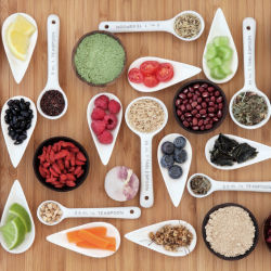 whole food ingredients in measuring cups on a wooden table