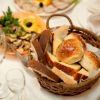 A dinner table at a restaurant with the bread basket in focus
