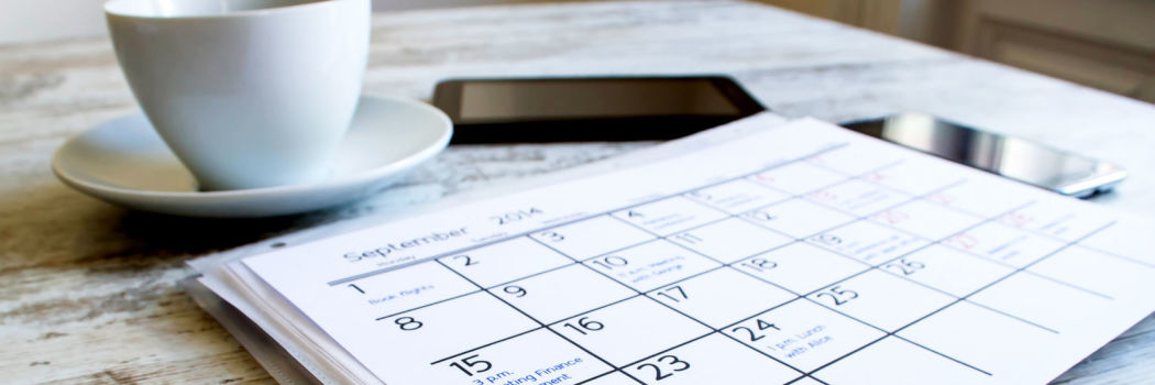 Cup of coffee in front of a calendar