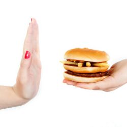 A hand halting a cheeseburger